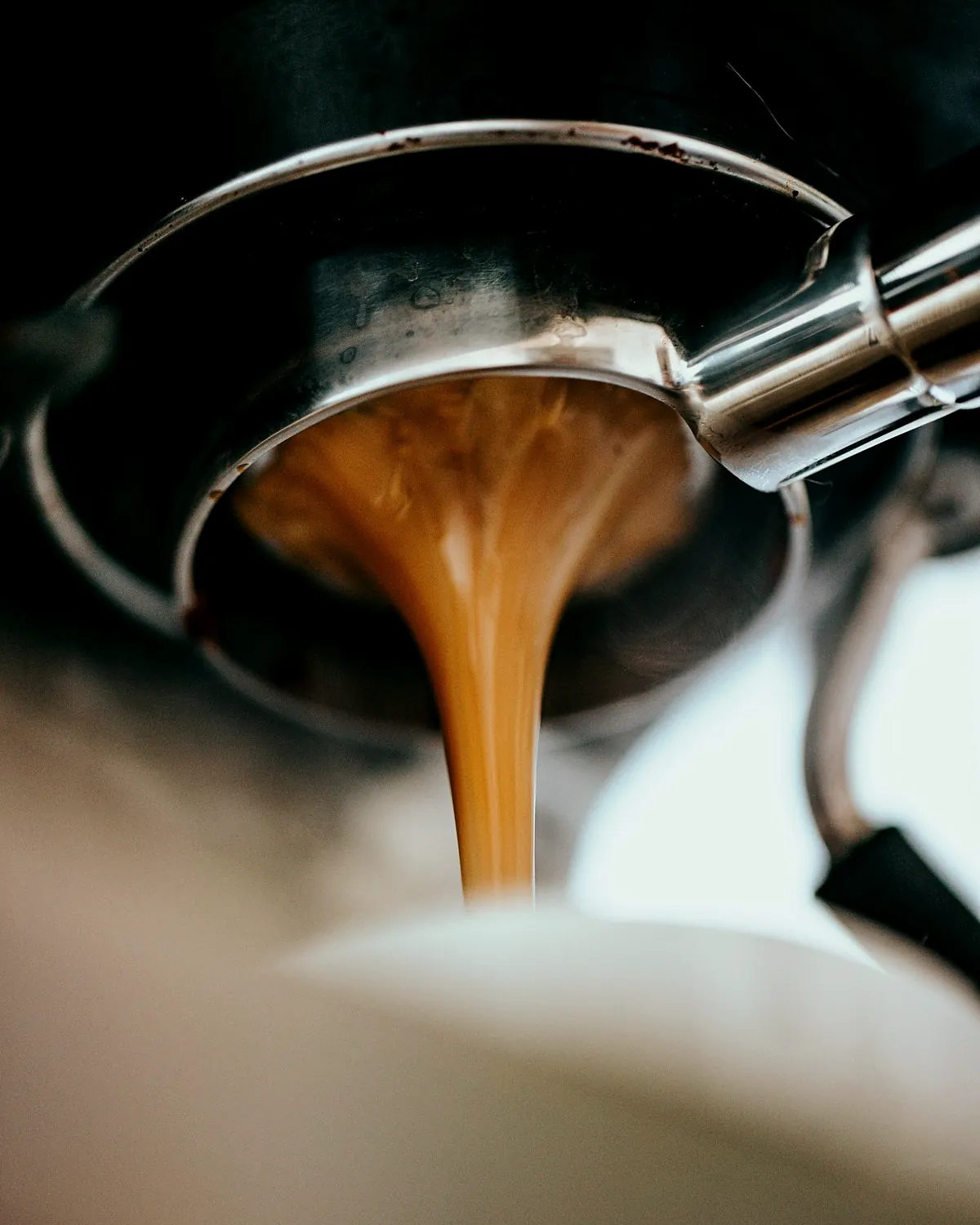 Espresso running from the machine into a cup