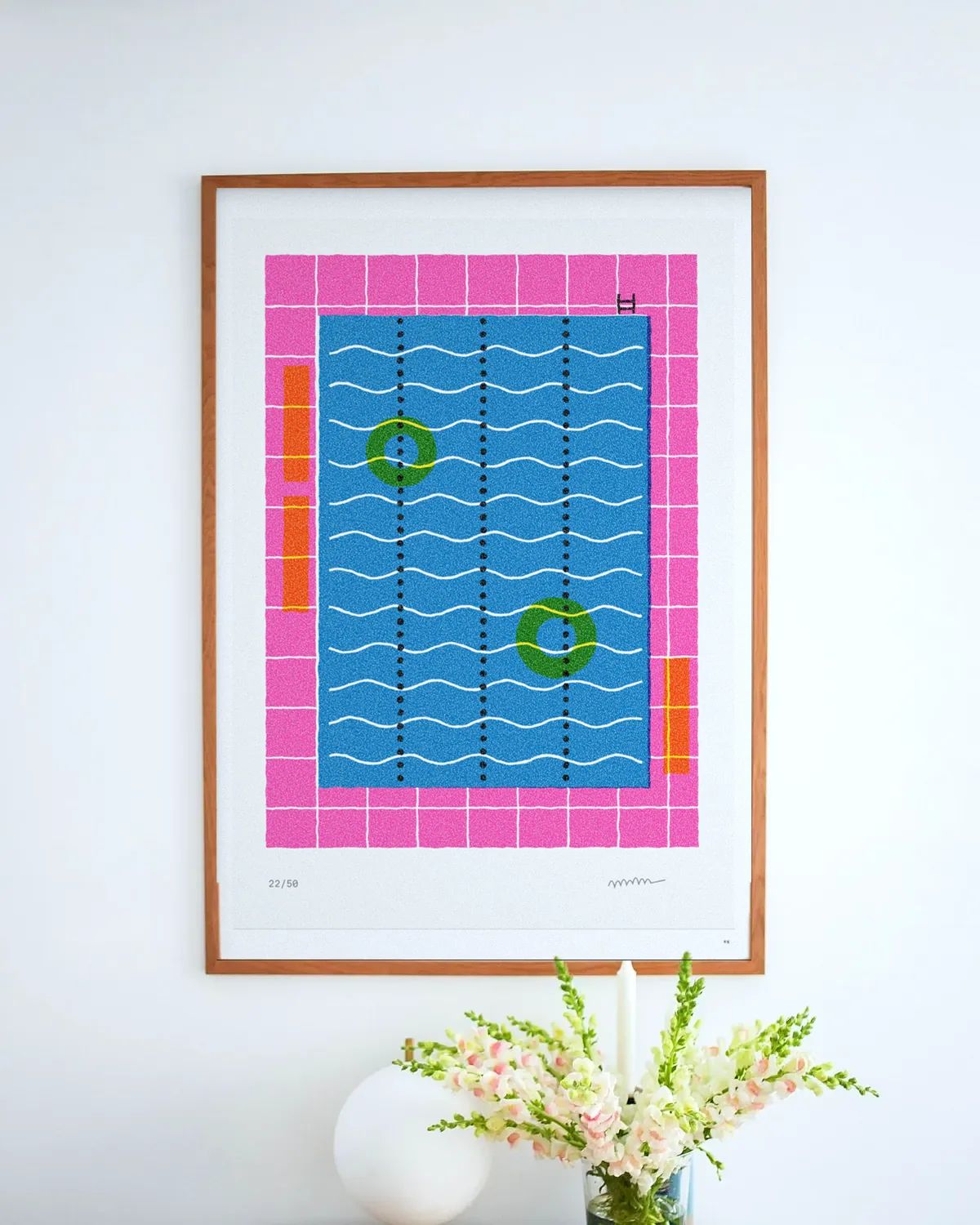 Lido from the high board in an oak frame above a table with flowers.