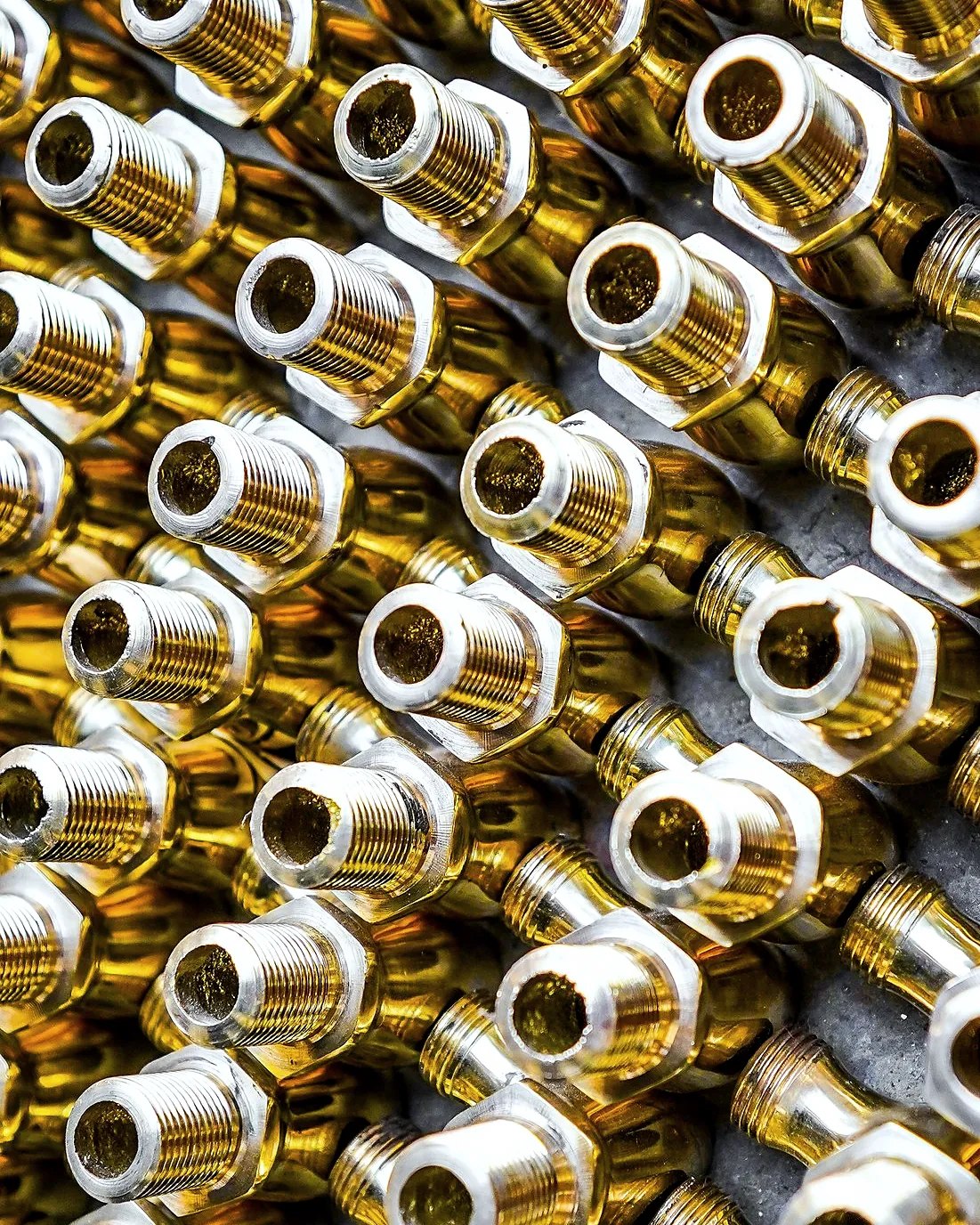 Rows of brass threaded fittings packed close together