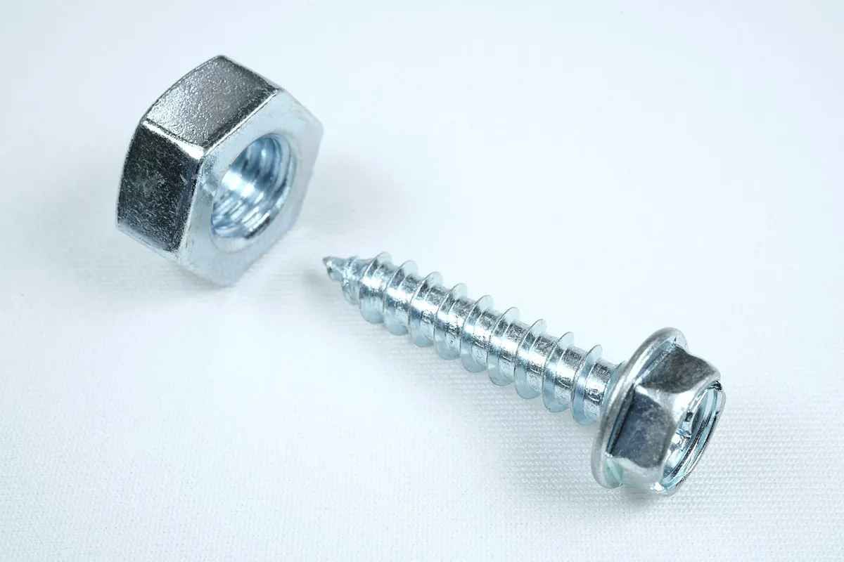 A zinc plated nut and a hex head screw