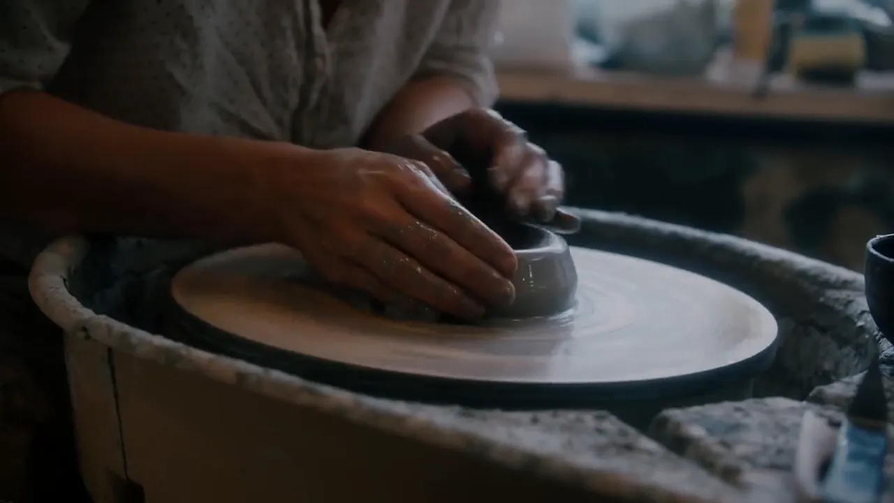 Video still at 0:06. Both hands close round the wall and bring it in