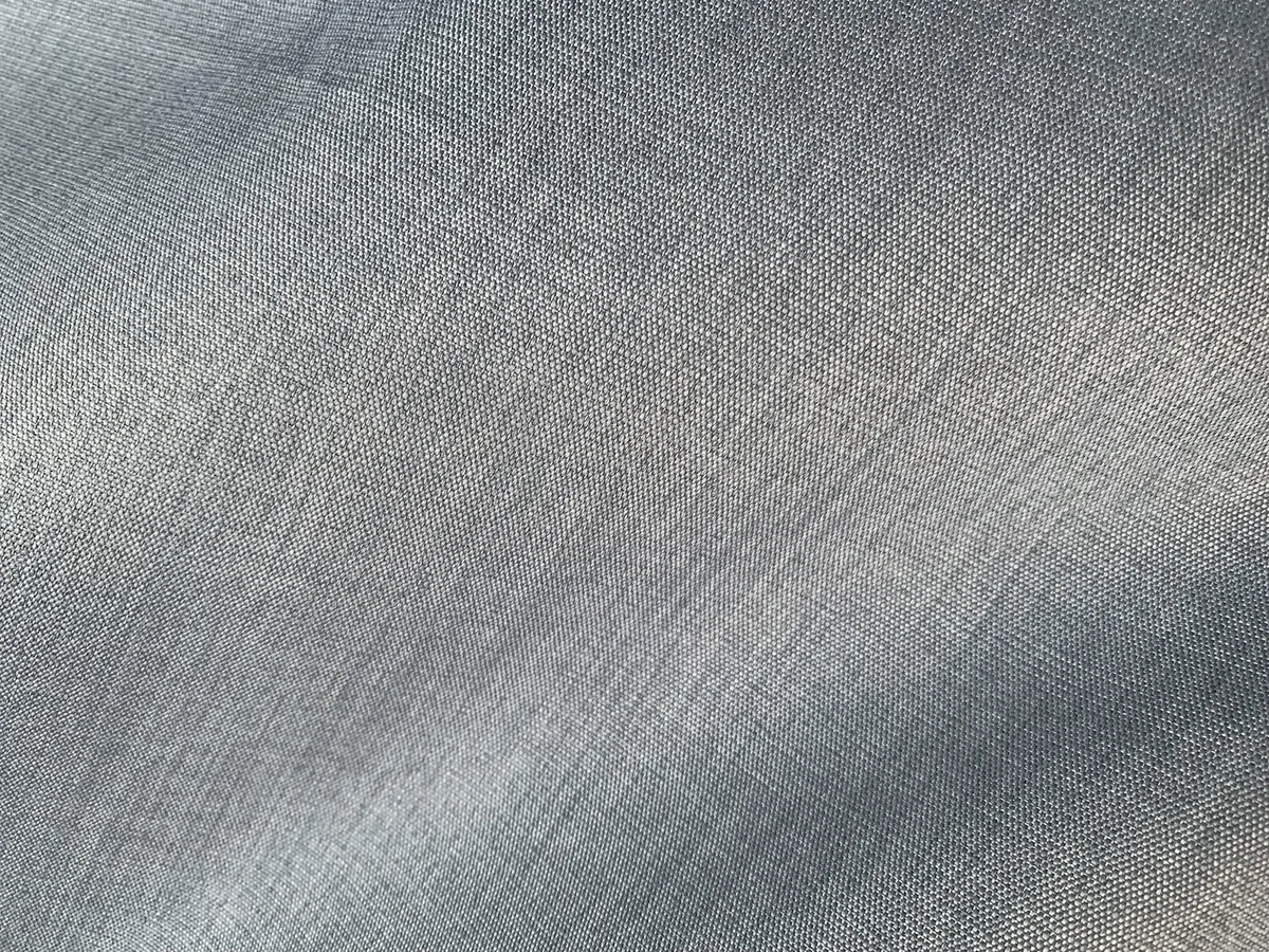 Close view of plain woven linen in grey blue, with the slubs of the flax yarn visible