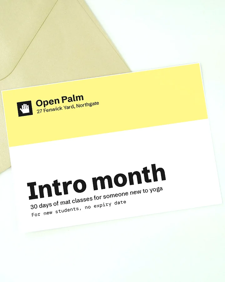An Open Palm intro month gift card on a kraft envelope next to a sprig of purple flowers