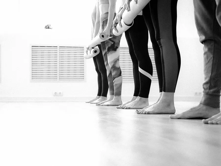Bare feet and ankles in a line, each with a resistance band