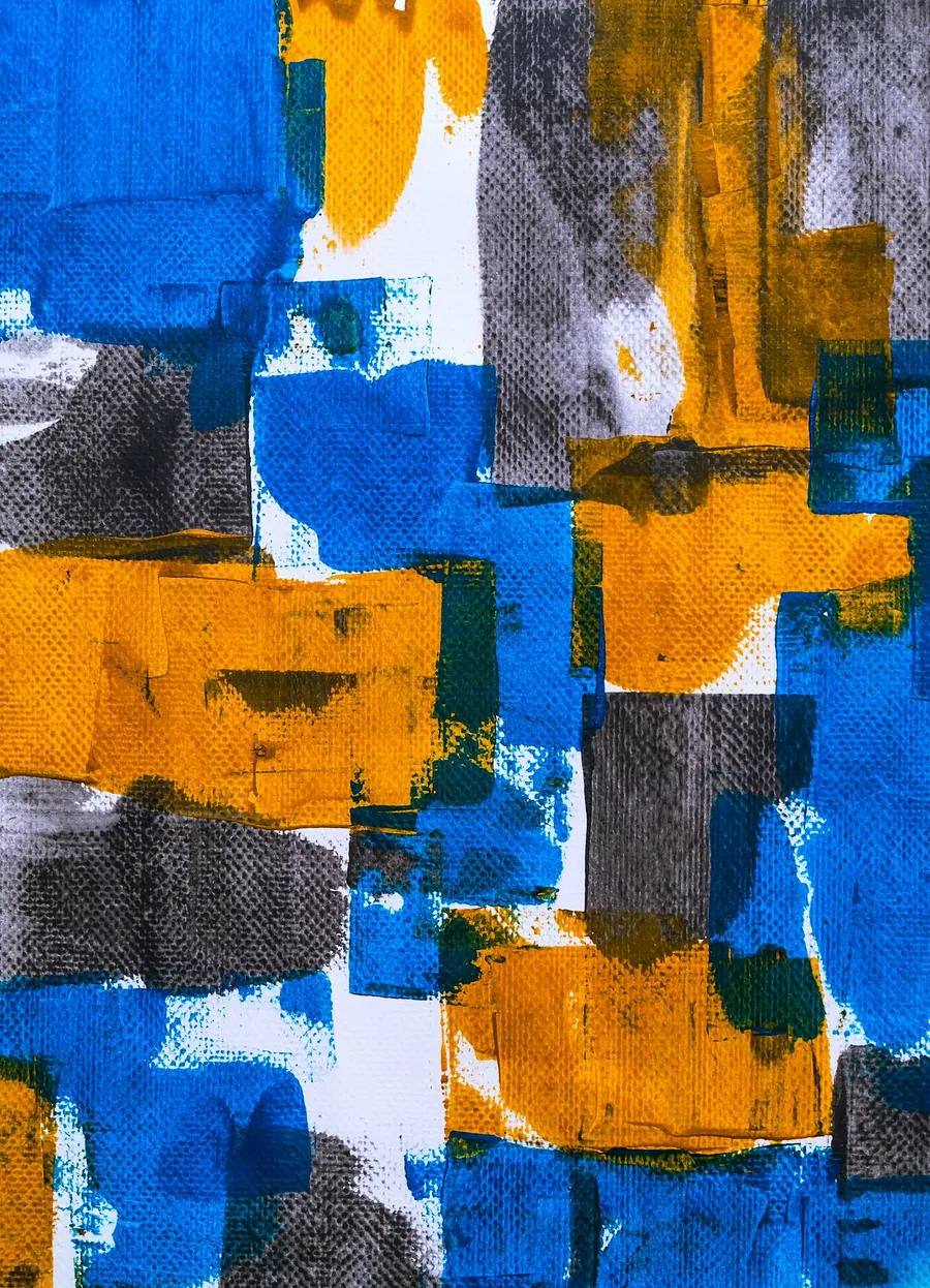 Collage of torn papers in bright blue, ochre and grey
