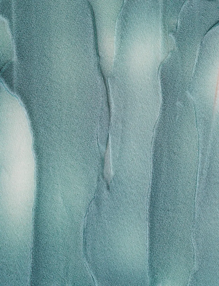Pale celadon green glaze that has run in soft vertical ridges