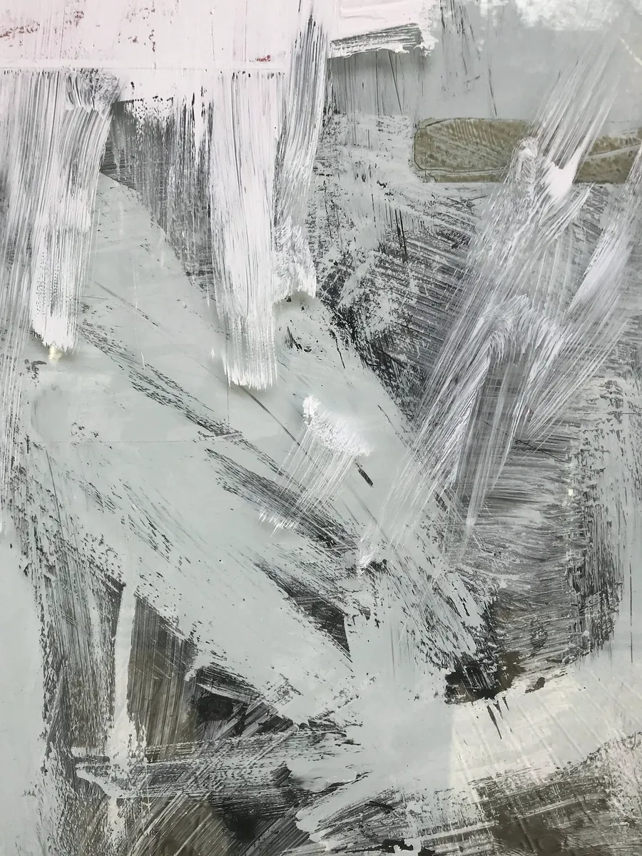 Grey, white and black brush strokes sweeping across a pale ground