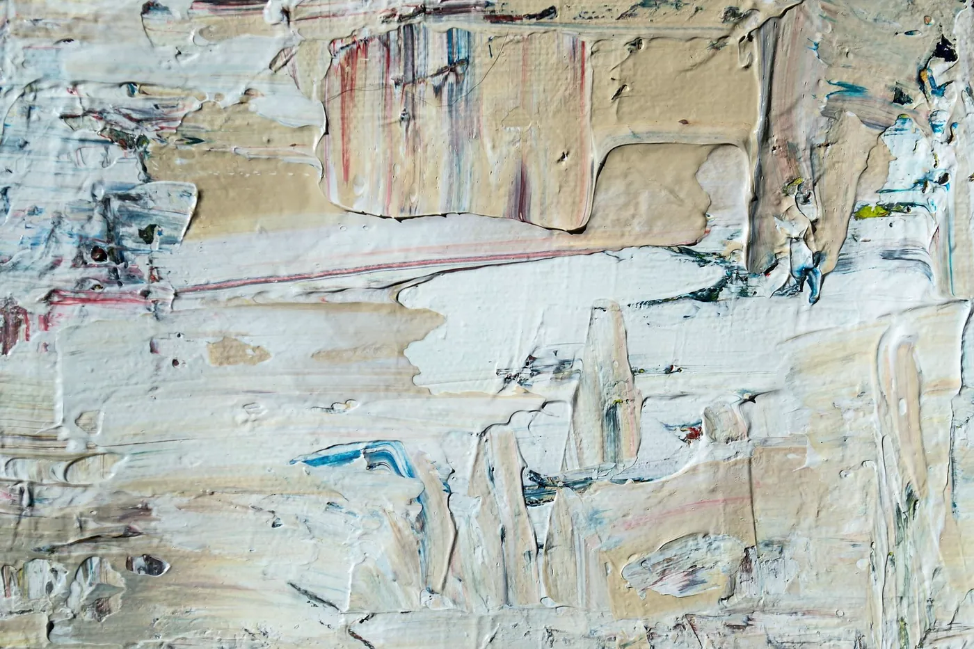 Thick off-white paint in knife strokes, with thin lines of blue, red and ochre showing through