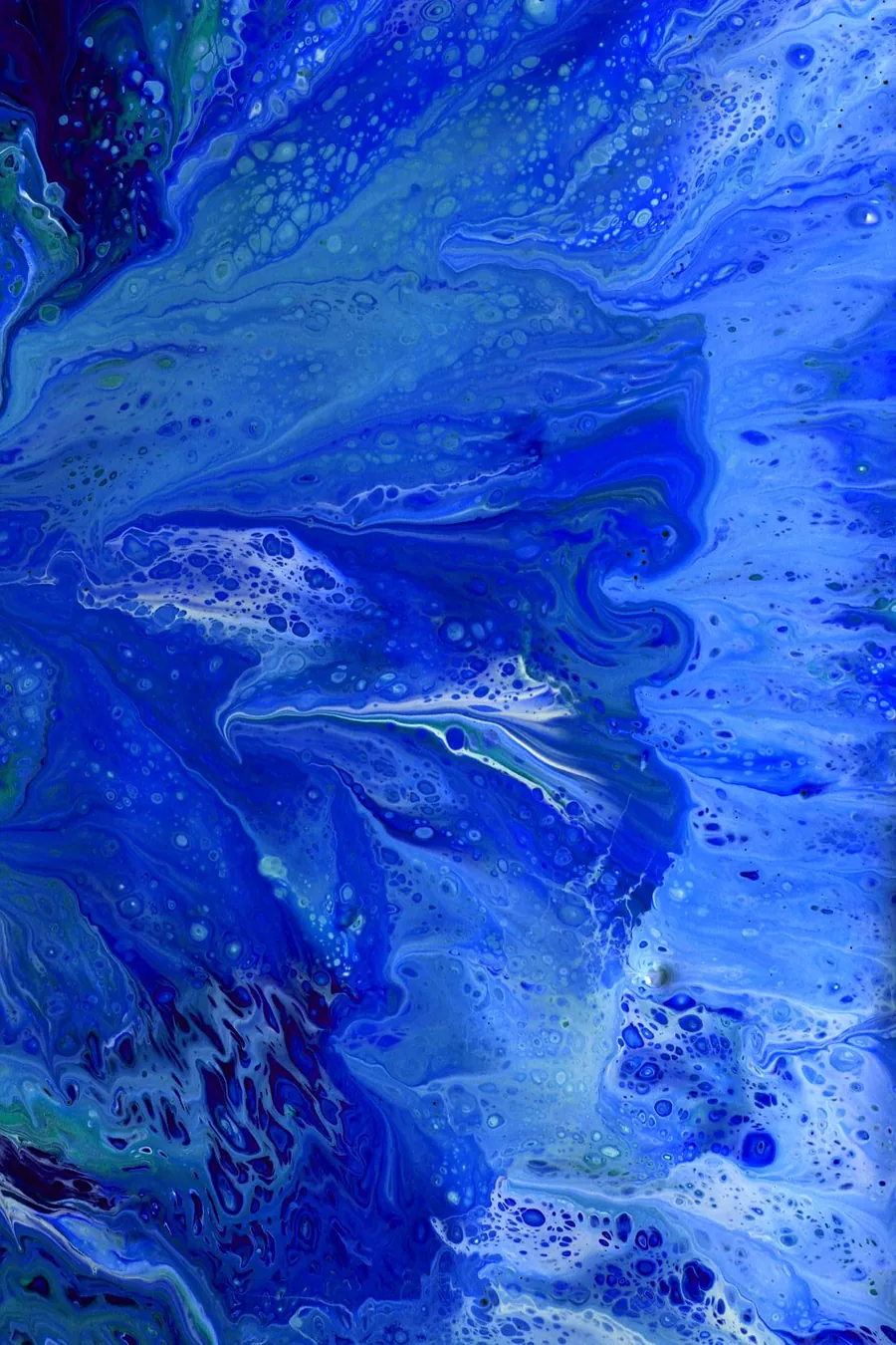 Poured acrylic in deep and pale blues, with small white cells along the edges of the pour