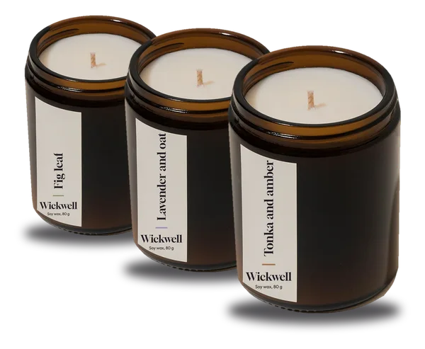 Three mini amber candle jars labelled Fig leaf, Lavender and oat and Tonka and amber
